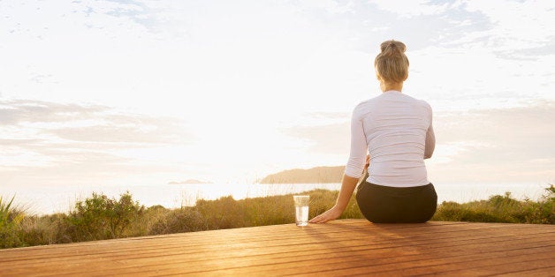 Caucasian couple admiring scenic view of ocean from wooden deck