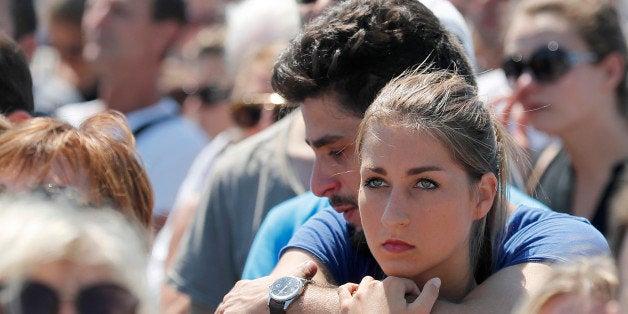 People observe a minute of silence on the famed Promenade des Anglais in Nice, southern France, to honor the victims of an at