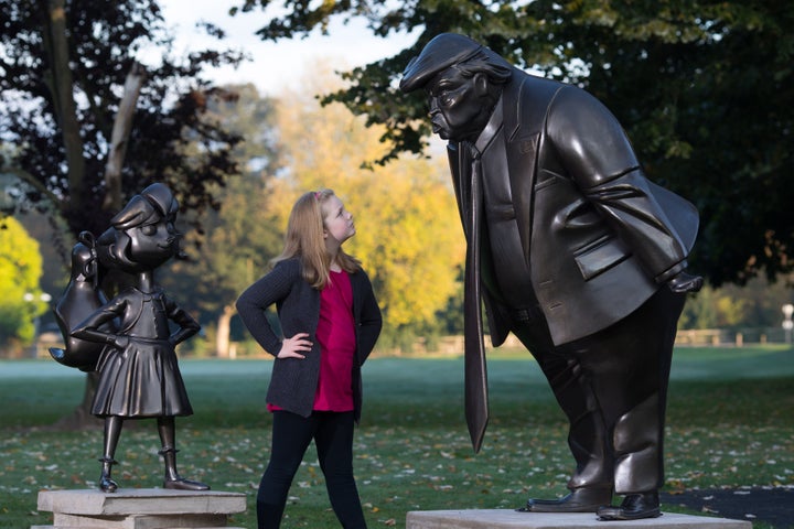 Mollie Sutton, eight, from Romford takes a look at a statue of Roald Dahl's Matilda.