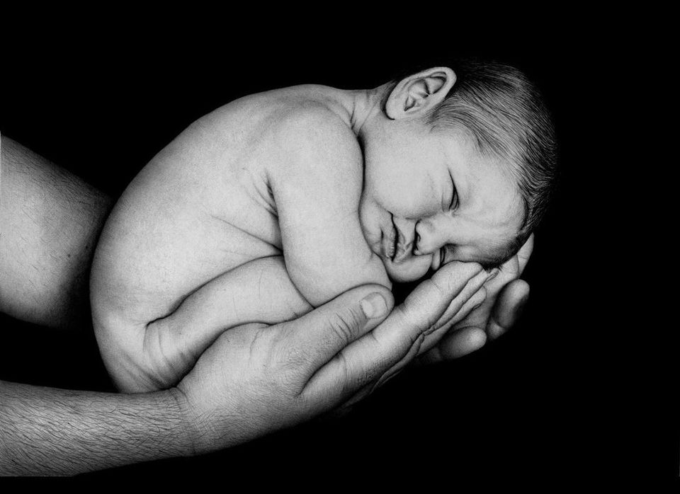 "Baby Cradled in Dad's Hands"
