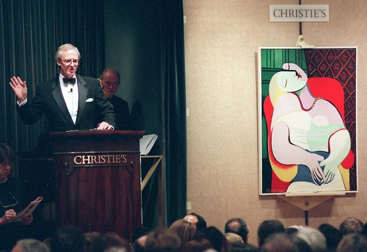 NEW YORK, UNITED STATES: Christopher Burge, chairman of Christie's (L), starts the bidding for Pablo Picasso's painting, 'Le Reve', 10 November in New York at an auction of the collection of Victor and Sally Ganz. The painting, one of 58 pieces of 20th century art offered for sale, was bought for 48 million USD by an unidentified bidder. AFP PHOTO Stan HONDA (Photo credit should read STAN HONDA/AFP/Getty Images)