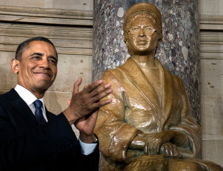 US President Barack Obama applauds after unveiling a statue of Rosa Parks during an unveiling in Statuary Hall on Capitol Hill February 27, 2013 in Washington, DC. US President Barack Obama, Speaker of the House John Boehner (R-OH) and others attended the ceremony to unveil a statue of American civil rights era icon Rosa Parks. AFP PHOTO/Brendan SMIALOWSKI (Photo credit should read BRENDAN SMIALOWSKI/AFP/Getty Images)