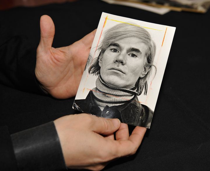 AMHERST, NH - JANUARY 16: RR Auction Vice President Bobby Livingston holds a news photograph of Andy Warhol on January 16, 2013 at RR Auction in Amherst, New Hampshire. (Photo by Paul Marotta/Getty Images)