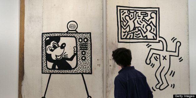 This picture taken on April 17, 2013 shows a spectator looking at an untitled art creation by US artist Keith Haring at the Musee d'Art Moderne (Modern Art Museum), in Paris, two days before the opening of an exhibition dedicated to Haring's work, 23 years after his death. The exhibition will last from April 19 to August 18. AFP PHOTO / FRANCOIS GUILLOT RESTRICTED TO EDITORIAL USE, MANDATORY MENTION OF THE ARTIST UPON PUBLICATION, TO ILLUSTRATE THE EVENT AS SPECIFIED IN THE CAPTION (Photo credit should read FRANCOIS GUILLOT/AFP/Getty Images)