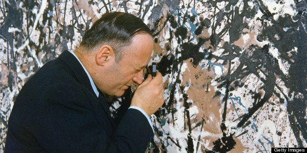 American museum curator James J. Rorimer (1905 - 1966), Director of the Metropolitan Museum of Art (MoMA), uses a pocket magnifying lens to examine the Jackson Pollock painting 'Autumn Rhythm' (1950) with a magnifying lens, New York, New York, February 1959. (Photo by Walter Sanders/Time & Life Pictures/Getty Images)