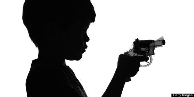 B&W Silhouette of a boy holding a toy gun