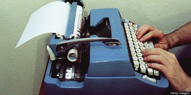 Man using typewriter, close-up of typewriter (grainy)