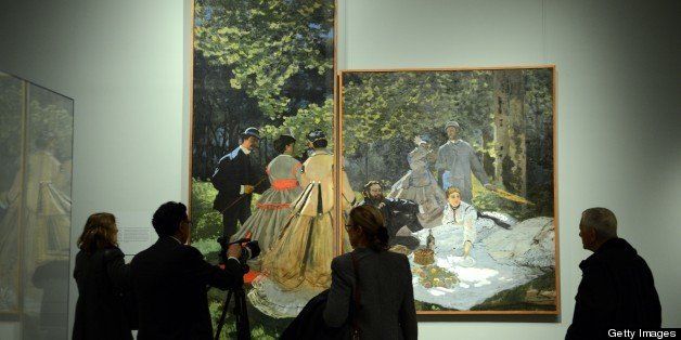 TO GO WITH AFP STORY BY BRIGITTE DUSSEAU People at a media preview look at 'Luncheon on the Grass, 1865-66' (L, large panel) and 'Luncheon on the Grass, 1865-66' (R) by Claude Monet in the exhibition 'Impressionism, Fashion, and Modernity' February 19, 2013 at The Metropolitan Museum of Art in New York. The look at the role of fashion in the works of the Impressionists and their contemporaries shows 80 major paintings with period costumes, accessories, fashion plates, photographs, and popular prints. AFP PHOTO/Stan HONDA (Photo credit should read STAN HONDA/AFP/Getty Images)