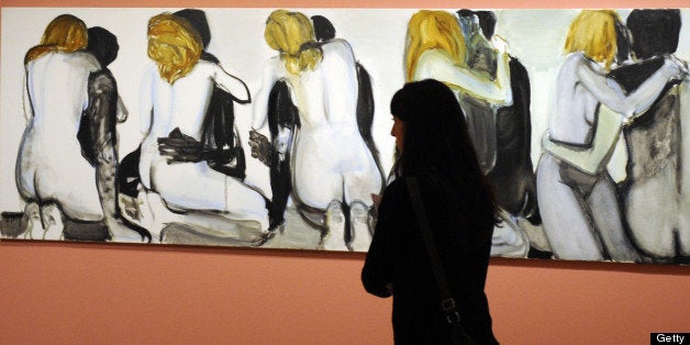 A visitor looks at the painting 'Couples' of Marlene Dumas (1994) during the opening of the exhibition 'Tears of Eros' at the