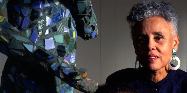 LOS ANGELES - 1994: Portrait session with artists Alison Saar (seated next to her sculpture) and mother Betye Saar (standing, her assemblage behind her) in Los Angeles in 1994. (Photo by Ann Summa/Getty Images)