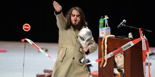 German artist Jonathan Meese performs his play 'Generaltanz den Erzschiller' on stage at the National Theatre in Mannheim, western Germany, on June 26, 2013. Meese's scandal performance, that was part of the International Schiller Days theatre festival, included showing the Nazi salute and bashing spectators. AFP PHOTO / DPA / ULI DECK / GERMANY OUT (Photo credit should read ULI DECK/AFP/Getty Images)