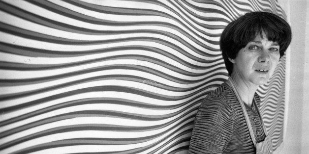 26th July 1979: Bridget Riley, British painter and leading figure in the Op Art movement, standing in front of one of her curving 'line' paintings at her studio. (Photo by Evening Standard/Getty Images)