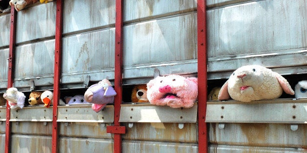 GLASTONBURY, ENGLAND - JUNE 28: A sculpture by Banksy, called 'The Sirens of the Lambs', depicting a truck full of shrieking cuddly animals being taken to slaughter, drives through the festival site during day two of the Glastonbury Festival at Worthy Farm in Pilton on June 28, 2014 in Glastonbury, England. Tickets to the event, which is now in its 44th year, sold out in minutes even before any of the headline acts had been confirmed. The festival, which started in 1970 when several hundred hippies paid Â£1, now attracts more than 175,000 people. (Photo by Jim Dyson/Getty Images)