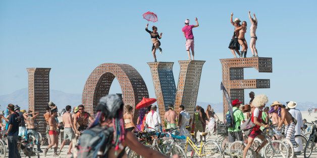 BLACK ROCK CITY, NV - SEPT 2: First-time Burner Sonja Lercer of Whistler, B.C., Canada, dances on the LOVE installation at last week's 25th annual Burning Man festival. (Photo by Keith Carlsen For the Washington Post)