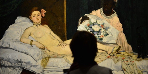 A woman looks at Edouard Manet's 'Olympia' on April 23, 2013 in Venice, during the 'Manet Return to Venice' exhibition, whic