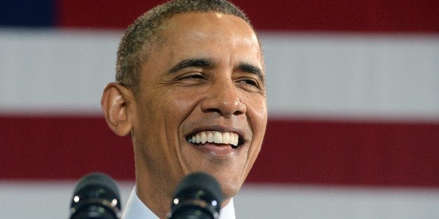 US President Barack Obama smiles as he speaks at the Costco in Lanham, Maryland, on January 29, 2014 to highlight the importance of raising the federal minimum wage for all Americans. Obama vowed to reverse a tide of economic inequality threatening the American dream Tuesday, seeking to outflank Republicans and revive a second term blighted by self-inflicted wounds and partisan warfare. In his annual State of the Union address, Obama promised to wield his executive powers in a 'year of action' to lift up workers, improve education and clean the environment if his foes in Congress balk at more sweeping action. AFP PHOTO/Jewel Samad (Photo credit should read JEWEL SAMAD/AFP/Getty Images)