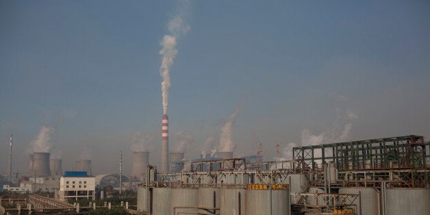 Vapor rises from cooling towers at a power plant, background, at the China Hongqiao Group Ltd. aluminum smelting facility in Zouping, China, on Monday, Nov. 4, 2013. China Hongqiao Group is China's largest private aluminum maker. Photographer: Brent Lewin/Bloomberg via Getty Images