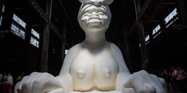 NEW YORK, NY - MAY 10: Kara Walker's 'A Subtlety,' a seventy-five and a half feet long and thirty-five and a half feet tall sphinx made in part of bleached sugar, is displayed at the former Domino Sugar Refinery on May 10, 2014 in the Williamsburg neighborhood of the Brooklyn borough of New York City. The show opened today, is free to the public and will run until July 6th. (Photo by Andrew Burton/Getty Images)