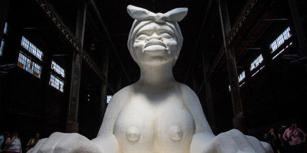 NEW YORK, NY - MAY 10: Kara Walker's 'A Subtlety,' a seventy-five and a half feet long and thirty-five and a half feet tall sphinx made in part of bleached sugar, is displayed at the former Domino Sugar Refinery on May 10, 2014 in the Williamsburg neighborhood of the Brooklyn borough of New York City. The show opened today, is free to the public and will run until July 6th. (Photo by Andrew Burton/Getty Images)