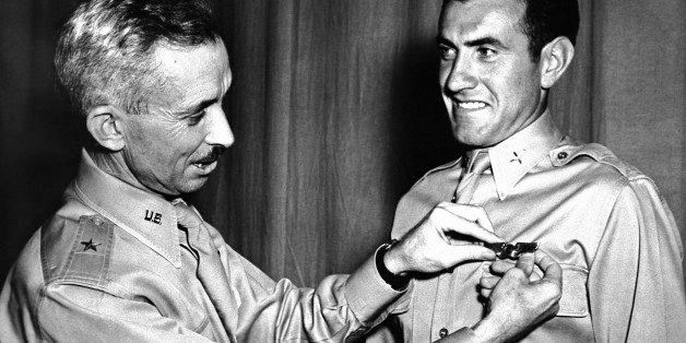 FILE - In this Aug. 14, 1942 file photo, Brig. Gen. Isaiah Davics, commanding general at the Midland, Tex., Army Flying School, pins a pair of silver bombardier wings on Lt. Lou Zamperini. Zamperini, the former track star who was adrift 47 days in the Pacific after an Army Air Force bombing mission against the Japanese in the Pacific, and had been presumed dead, was named Grand Marshal of the 126th Tournament of Roses in ceremonies Friday, May 9, 2014, in Pasadena, Calif. (AP Photo, File)