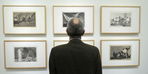 A visitor looks at engravings by Spanish master Francisco de Goya on March 16, 2010 at Palazzo Reale museum in Milan. The exhibition 'Goya e il mondo moderno' (Goya and the modern world) runs from March 17 to June 27, 2010 and shows over 180 artworks including paintings, engravings and drawings tracing the relationship between Goya (1746-1828) and other artists who have made art history over the last two centuries. AFP PHOTO / DAMIEN MEYER (Photo credit should read DAMIEN MEYER/AFP/Getty Images)