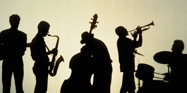 Silhouette of five players in jazz band, white background