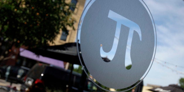 The symbol for Pi is seen on a window at Pi pizza Thursday, June 4, 2009, in St. Louis. (AP Photo/Jeff Roberson)