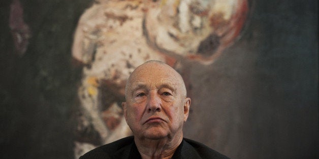 German painter Georg Baselitz addresses a press conference, sitting in front of his painting 'Grosse Nacht im Eimer' (Big Night Down the Drain - 1962-1963), during a press preview of his exhibition 'Baselitz, the Berlin Years' at the Villa Schoeningen, in Potsdam February 3, 2012. Baselitz studied in Berlin and started painting in the city, from 1956 to 1962. AFP PHOTO / JOHN MACDOUGALL (Photo credit should read JOHN MACDOUGALL/AFP/Getty Images)