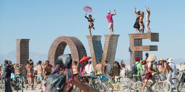 BLACK ROCK CITY, NV - SEPT 2: First-time Burner Sonja Lercer of Whistler, B.C., Canada, dances on the LOVE installation at last week's 25th annual Burning Man festival. (Photo by Keith Carlsen For the Washington Post)