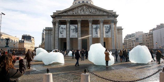 PARIS, FRANCE - DECEMBER 03: A woman takes a picture of a mass of ice harvested from Greenland during an installation entitled 'Ice Watch' by Danish-Icelandic artist Olafur Eliasson in front of the Pantheon on December 3, 2015 in Paris, France. France hosts climate change conference COP21 in Paris from November 30 to December 11, 2015. (Photo by Chesnot/Getty Images)