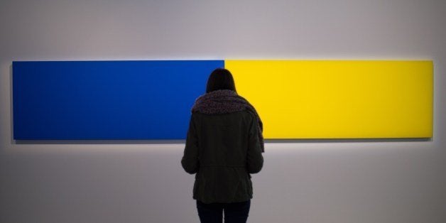A visitor looks at the artwork 'Two Panels - Blue-Yellow' (1970) by US artist Ellsworth Kelly as part of the exhibition 'J'ai