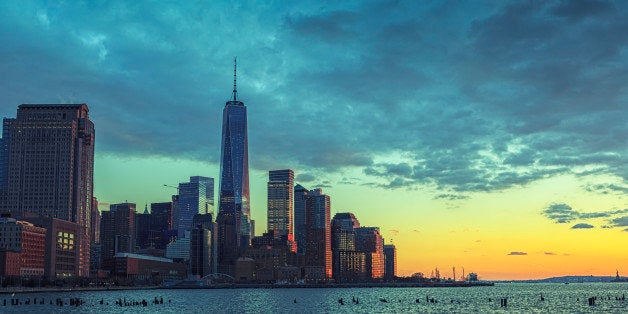 Dramatic sky over Manhattan with Freedom tower during sunset