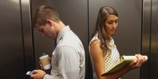 Business people ignoring each other in elevator