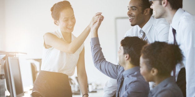 Business people cheering in office