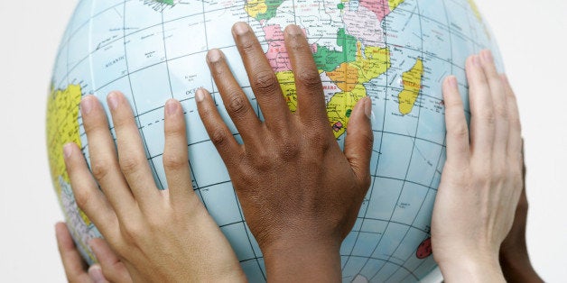 People holding up a globe