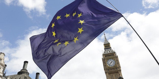 A European Union flag is held in front of the Big Ben clock tower in Parliament Square during a 'March for Europe' demonstration against Britain's decision to leave the European Union, central London, Britain July 2, 2016. Britain voted to leave the European Union in the EU Brexit referendum. REUTERS/Paul Hackett