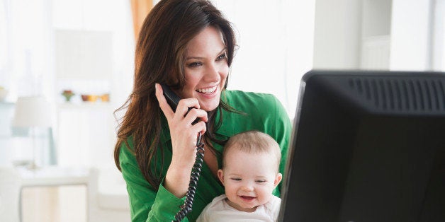 USA, New Jersey, Jersey City, Mother with baby daughter (6-11 months) working in home office