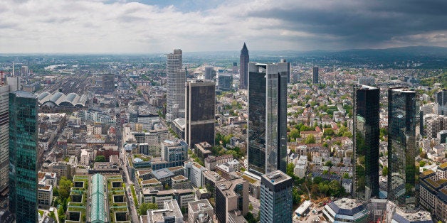 Panoramic vista across the skyscrapers, towers and landmarks of central Frankfurt's Bankenviertel financial district, from the banks of the River Main past the European Central Bank, the busy Hauptbahnhof railway station, international banks and the famous Messe exhibition complex to the green hills of Taunus, Germany. ProPhoto RGB profile for maximum color fidelity and gamut.