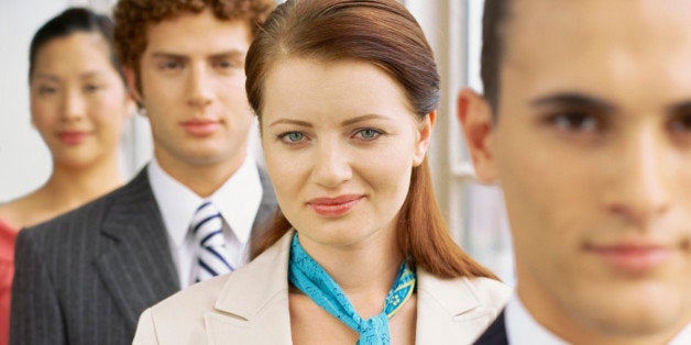 portrait of two businessmen and two businesswomen in a row