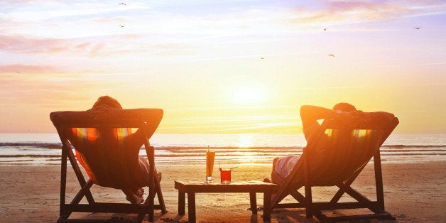 happy couple enjoy luxury sunset on the beach during summer vacations