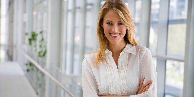 Smiling businesswoman with arms crossed