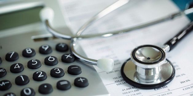 Calculator and stethoscope on financial statement concept for finance health check or cost of healthcare
