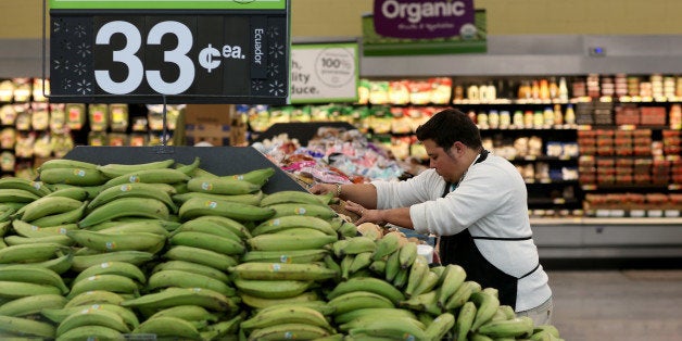 MIAMI, FL - FEBRUARY 19: Walmart employee Dayngel Fernandez works in the produce department stocking shelves at a Walmart store on February 19, 2015 in Miami, Florida. The Walmart company announced Thursday that it will raise the wages of its store employees to $10 per hour by next February, bringing pay hikes to an estimated 500,000 workers. (Photo by Joe Raedle/Getty Images)