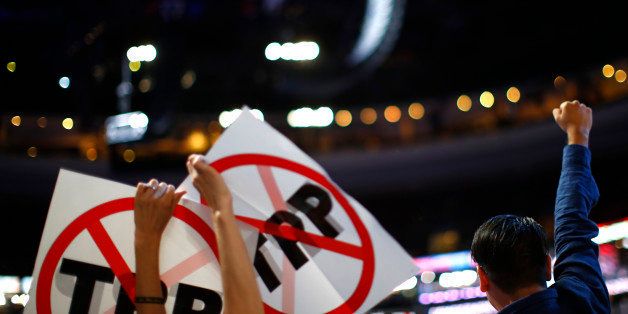 Delegates protesting against the Trans Pacific Partnership (TPP) trade agreement hold up signs during the first sesssion at the Republican National Convention in Cleveland, Ohio, U.S. July 18, 2016. REUTERS/Carlos Barria 