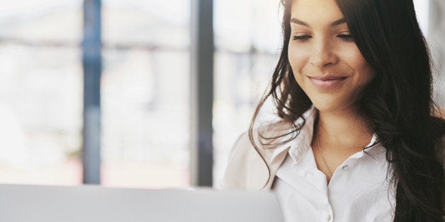 Shot of a young businesswoman working on a laptop in an office