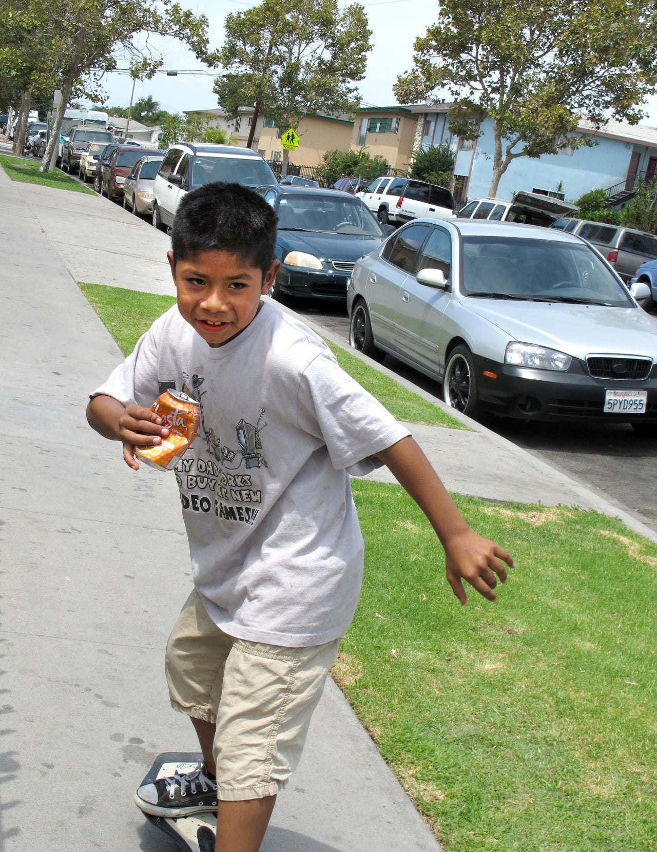 In the summer of 2014, Cesar Gaspar, 8, skateboards through his Townsend Street neighborhood in Santa Ana during a community barbecue.