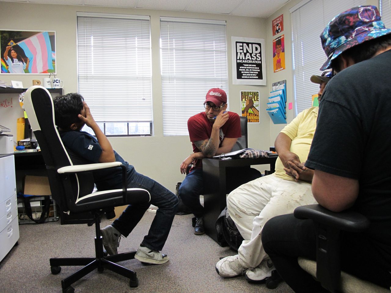 Cesar, 12, talks to youth organizers Ignacio Rios (center) and Ramon Campos (far right) while his father, Cesar Gaspar Sr., listens during an April 2018 mentoring session.