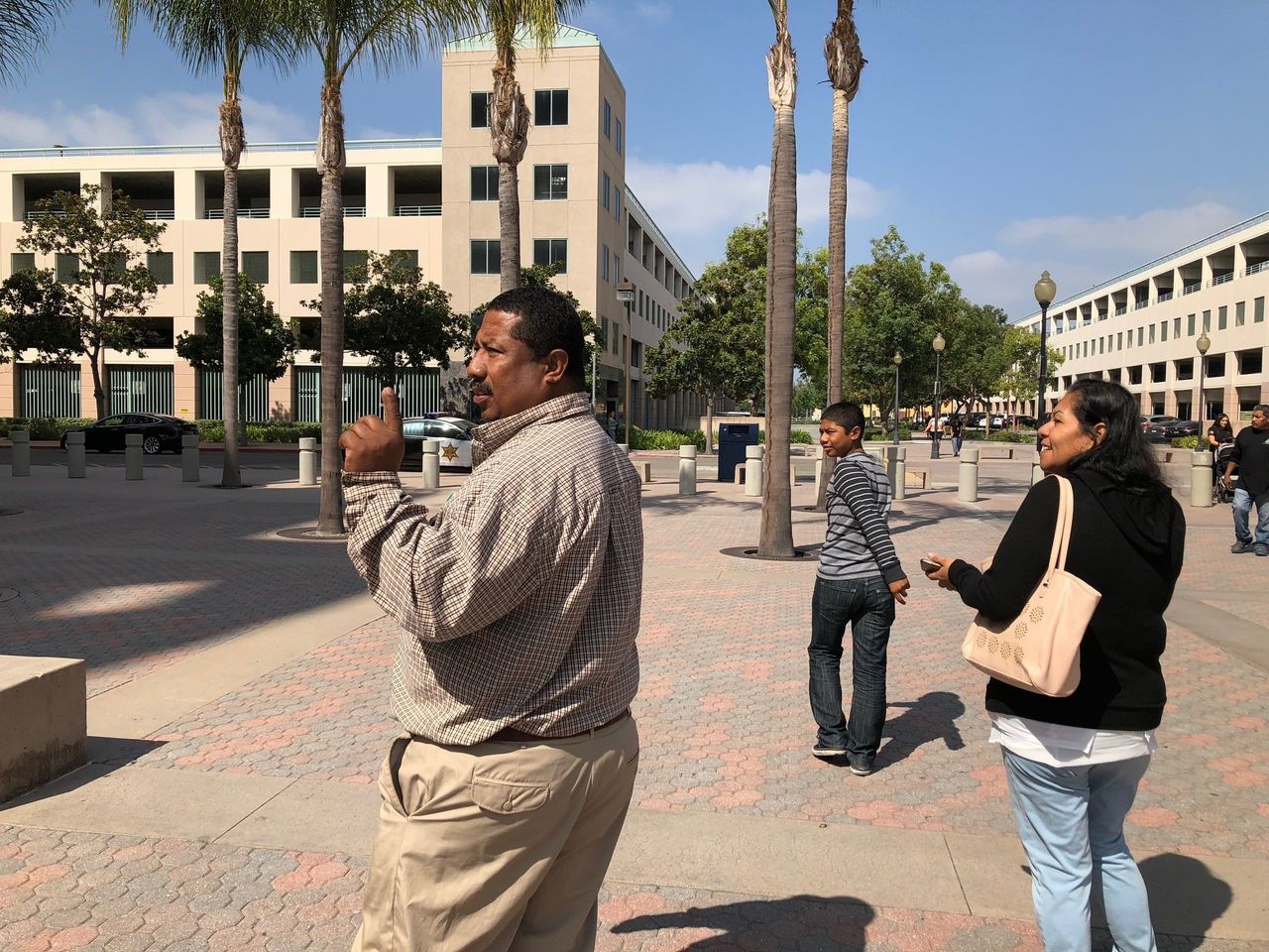 Cesar Gaspar Sr. (left), his wife, Kenia (right), and their son, Cesar (center), leave the Lamoreaux Justice Center in Orange after Cesar's August court hearing to celebrate with a family breakfast.