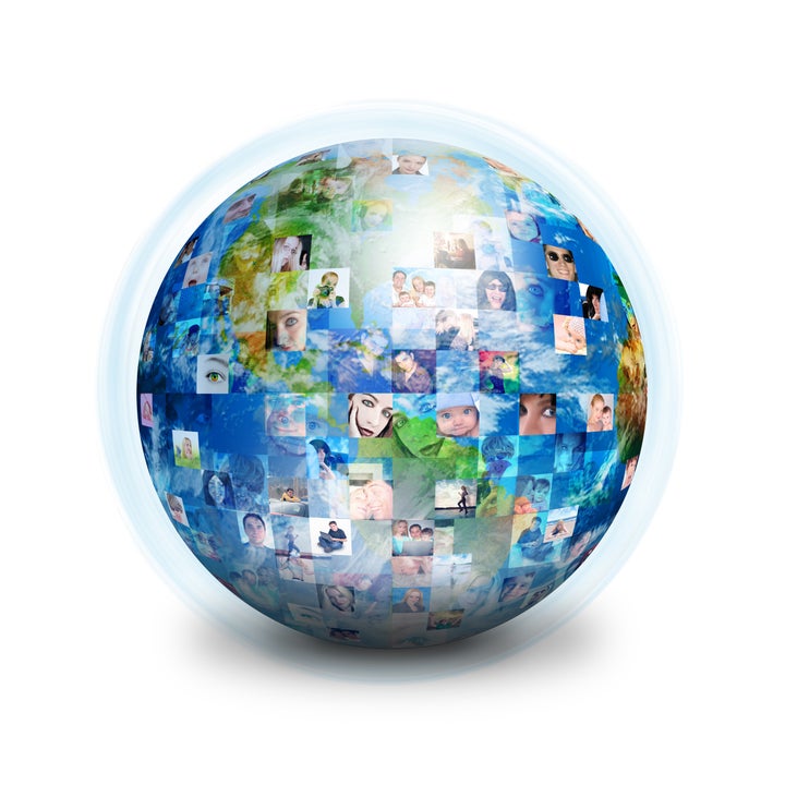 A globe is isolated on a white background with many different people's faces. Can represent a technology social network of friends and communication.