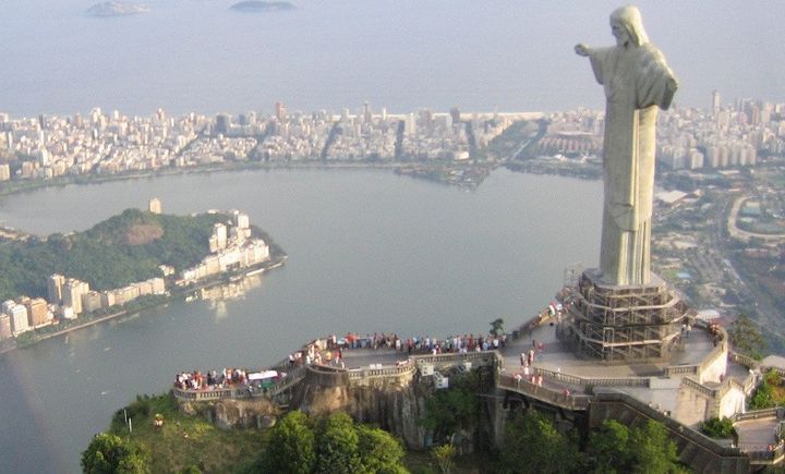 Description Cristo Redentor statue on top of Corcovado, a mountain towering over Rio de Janeiro. In the background the Ipanema and Leblon ... 